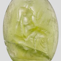 MET.Period:Hellenistic Date:2nd century B.C. Culture:Greek Medium:Glass, green Dimensions:Overall: 1 1/16 x 11/16 in. (2.7 x 1.8 cm) Classification:Gems
